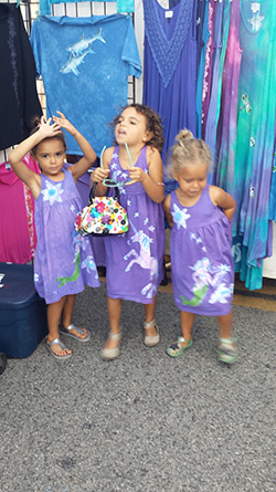 three girls mermaid unicorn dresses.